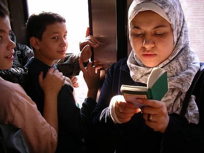reading koran on tube