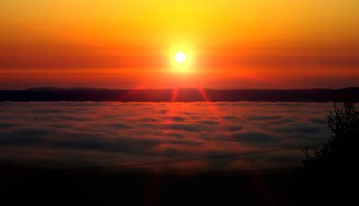 Sunset over low clouds