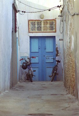 Blue door with  Motorped and bicycle