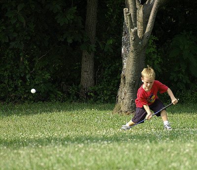 'young golfer teeing off'