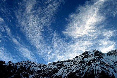 Wispy clouds over d mountain