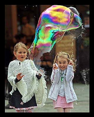 Kids enjoying big bubble burst