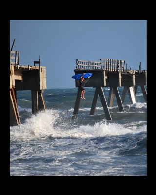 surfer jumpin off pier 
