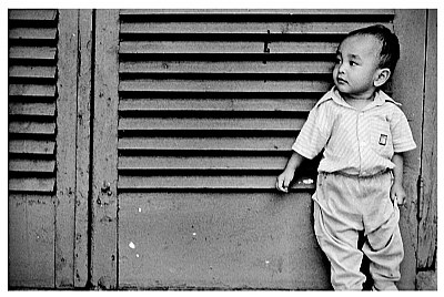 child leaning against the door