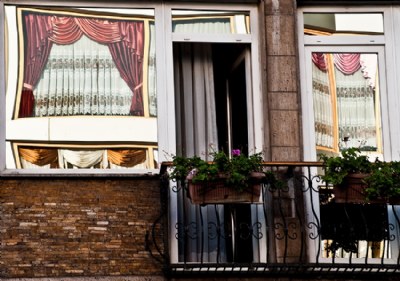 Windows with Curtains of the opposite street side windows.