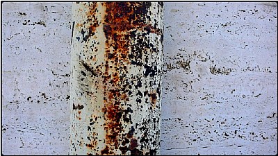 rusty tube on white wall
