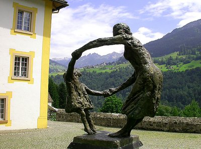 Statue with village in the background