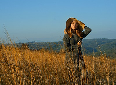 Girl and a dry autumn grass