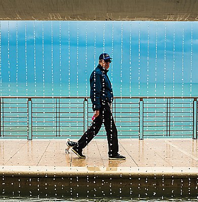 man with chihuahua under the rain