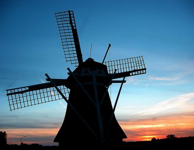 Mill in silhouette by Sunset
